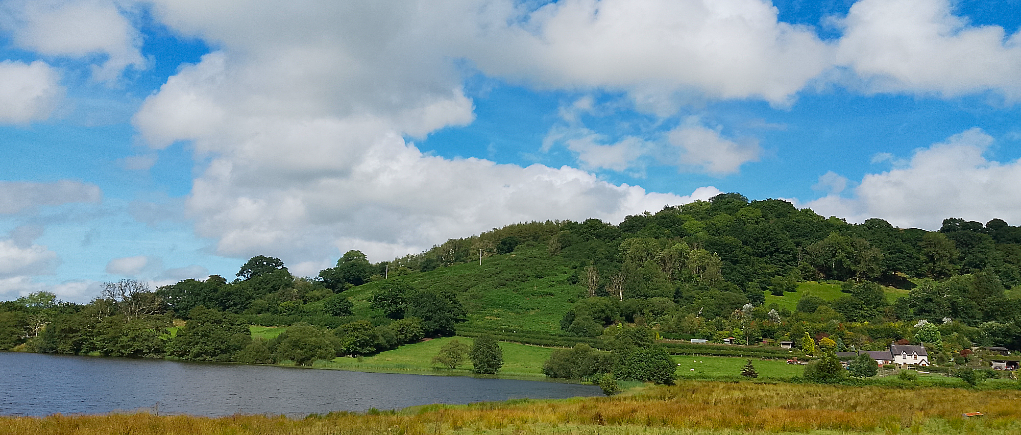 Lake and hill with blue sky